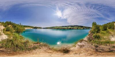 360 hdri panorama on limestone coast of huge green lake or river near pine forest with fluffy clouds in equirectangular full seamless spherical projection, VR content photo