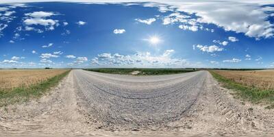 hdri 360 panorama of blue sky with awesome clouds on roadside of gravel road among fields in equirectangular full seamless spherical projection, for VR AR content or skydome replacement photo