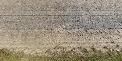 view from above on texture gravel road with median with lawn photo