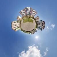abstract swirling tiny planet spherical panorama of multi-storey buildings of skyscrapers of a residential complex in the form of a butterfly, bugs, crabs in blue sky photo