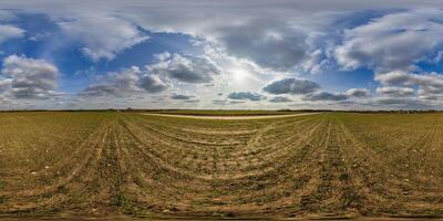 360 hdri panorama view among fields in spring day with beautiful clouds in equirectangular full seamless spherical projection, ready for VR AR or sky dome replacement photo