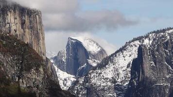 Sped Up Clouds Moving Up Mountain In Yosemite With Snow And Half Dome California video