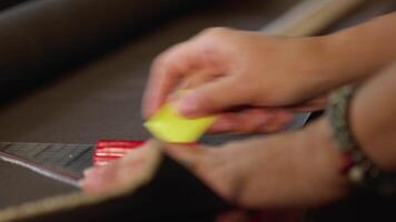Tailor Pointing a Line to Cut a Hard Fabric to Make a Bag video