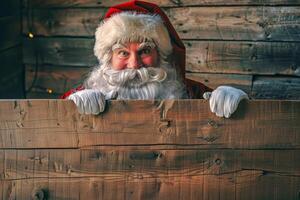 Santa Claus peeking out from behind wooden empty sign in a rustic cabin. Concept of Christmas, winter holidays, festive cheer, holiday. Greeting card, postcard, mockup, invitation, letter. Copy space photo