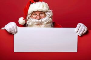 Santa Claus with Glasses Holding a Blank White Sign. Red background. Concept of Christmas, Holiday Season. Greeting card, postcard, mockup, invitation, letter. Copy space photo