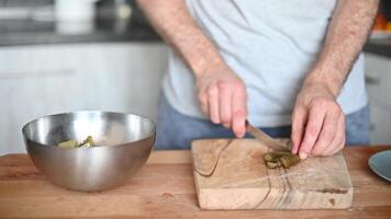 Woman slicing Salted pickles with knife from jar can, Cucumbers preservations, conservation. Salted pickled cucumbers in a wooden table. Preparing the salad video