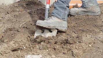 digging in the ground for plastic pipes for water and waste. video