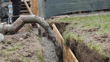 concreting of the foundation of the new building. pouring concrete into an excavation in the ground video