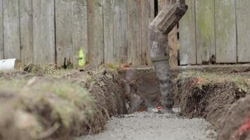 pouring concrete from a mixer truck with a hose into the foundation of the house video