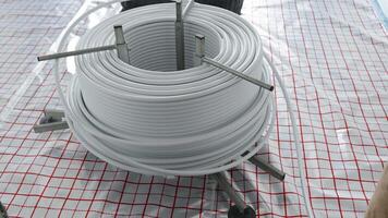 roll with pipe for underfloor heating in a new building video