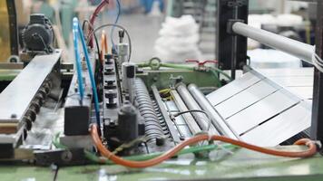 robotically automated machine for the production of plastic bags in a factory video