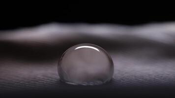 Drop of water on a bird feather, cold light, macro view video