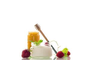 homemade sweet yogurt in a jar with strawberries, isolated on white background photo