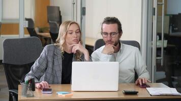 Professionals working together using one laptop in shared table in office. Businesspeople using a Tap bot application on their phone to earn cryptocurrency, mine coins and tokens. video