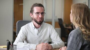 Businessman interviewing an applicant at his office. Two professional having a question and answer conversation in a modern office. video
