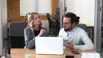 Two professionals working together in shared table and laptop in the office. Moving forward . video