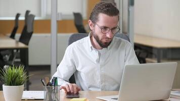 A businessman busy working at his desk. Man using Tap bot application on his phone to earn cryptocurrency, mine coins and tokens. video