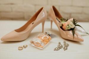 A pair of high heels and a bottle of perfume are displayed on a table. Concept of elegance and sophistication photo