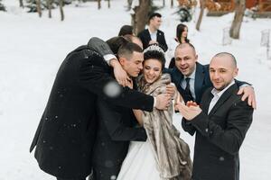 A bride and groom are surrounded by their friends and family, all of whom are smiling and hugging. The bride is wearing a fur stole and the groom is wearing a tie. Scene is joyful and celebratory photo
