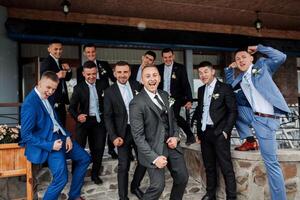 A group of men in suits are posing for a photo, with one man in the middle of the group making a funny face. Scene is lighthearted and fun, as the men are dressed up and posing for a picture together photo
