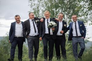 A group of men are dressed in suits and ties, with one man holding a bouquet of flowers photo