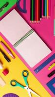 Composition of multi-colored stationery items laid out on the table. office, school FLAT LAY Copy space notebook. Back to school, vertical copy space video