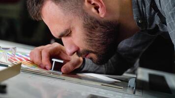 Worker checking print quality of graphics in modern printing house video