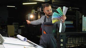 Funny designer dancing with swatch palette in hand at print factory video