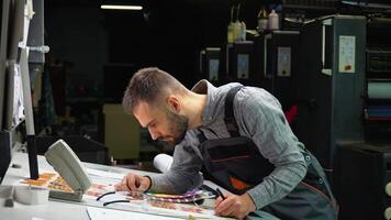 Graphic designer choosing colors from color palette. Concept of color management in the print production process video