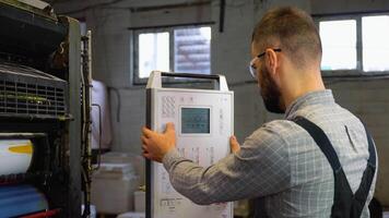 Print house worker setting parameters on modern offset printing machine video