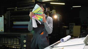 Funny designer dancing with swatch palette in hand at print factory video