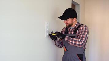 Electrician installing a socket on a wall video