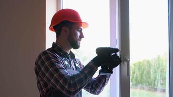 Construction worker installs a window frame in the room video