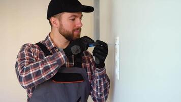 Electrician installing a socket on a wall video