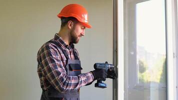 Professional construction worker installing pvc window or door in house. Handyman fixing the window with screwdriver video