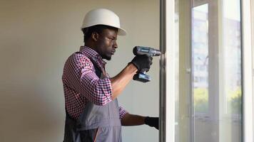 The black worker installing and checking pvc window or door in the house video