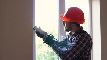Handyman fixing the window with screwdriver. Construction worker installing window in house video