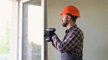 Construction worker installing and checking pvc window or door in the house video