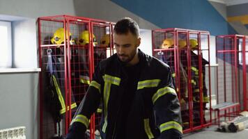 Fireman puts on a protective uniform video