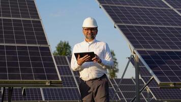 Portrait Of Senior Inspector Engineer With Digital Tablet in Solar Panels Power Farm video