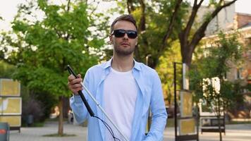 Blind man setting up walking cane on the street video