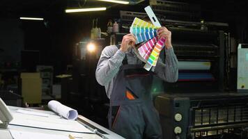 Funny designer dancing with swatch palette in hand at print factory video