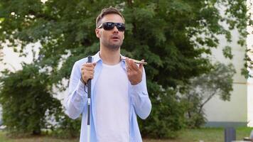 Blind man using voice control app in smartphone, innovations video