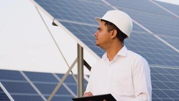 Indian engineer using digital tablet maintaining solar cell panels on station video