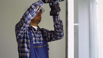 Indian industrial builder worker at window installation in new home video
