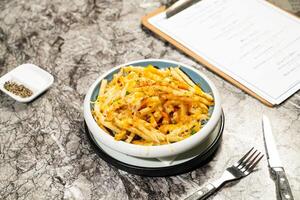 Poutine Cheese Fries with Gravy Sauce, fork and knife served in plate isolated on marble background side view of hong kong food photo
