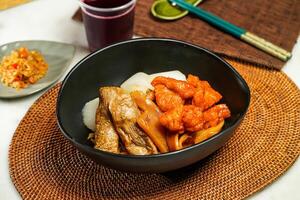 Siu yi mixed with coarse with drink and chopsticks served in pot isolated on napkin side view of japanese food photo