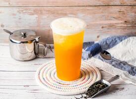 Iced Taiwan Green Tea with sugar pot and spoon served in disposable glass isolated on table side view of hong kong tea photo
