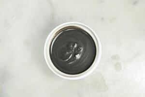 Sesame paste served in bowl isolated on grey background top view of asian food photo