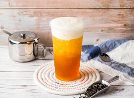 Iced Jasmine Green Tea with sugar pot and spoon served in disposable glass isolated on table side view of hong kong tea photo